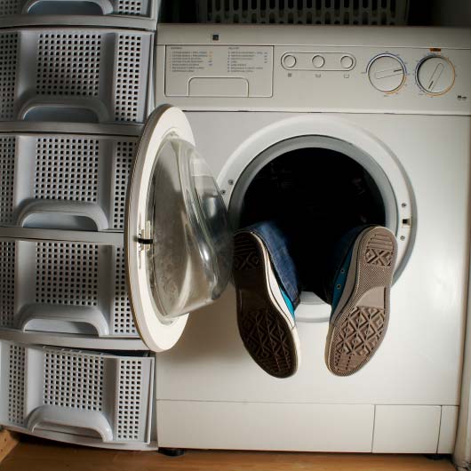 Feet poking out of a washing machine