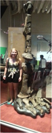 Elizabeth standing next to prehistoric bones at the Queensland Museum