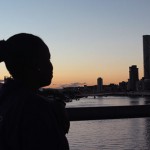 Mpho silhouette against Brisbane river at sunset