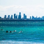 Gold Coast surfers and city skyline