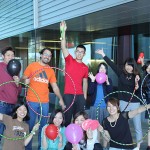 GELI students pose with balloons and hula hoops from mini olympics event.