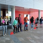 Students line up with balloons between their legs ready for a mini olympics event.