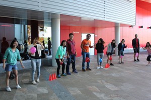 Students line up with balloons between their legs ready for a mini olympics event.
