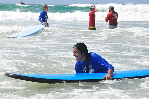 Tharshika with surf board in shallow water at The Spit
