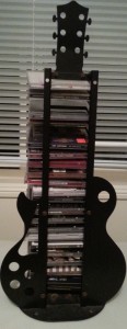Guitar-shaped CD stand - op shop
