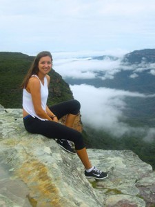 Melissa sitting on rocks above the clouds in the Blue Mountains NSW