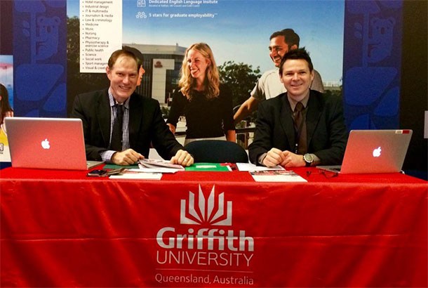 Prof Peter Woods and Stephen Lewin sitting at the Griffith Uni booth at the Latino Australia expo in Bogota.