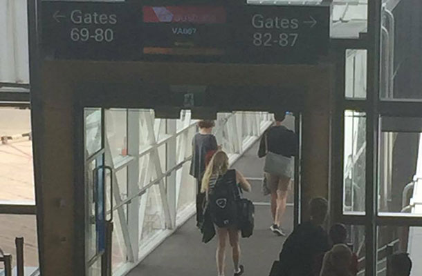 Brianna walks down the airbridge to board her flight.