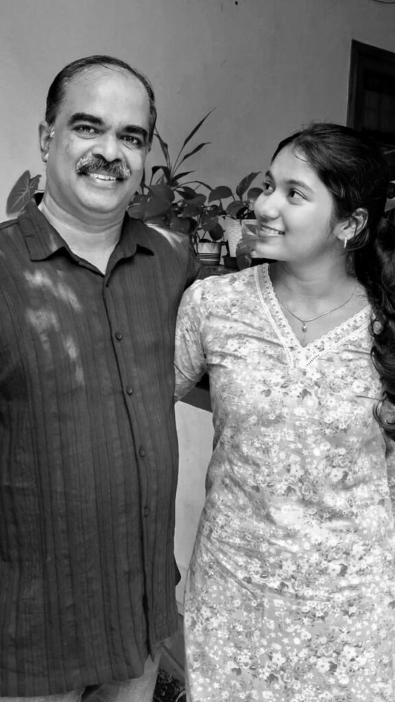 Griffith international student Neha smiling with her father at home.